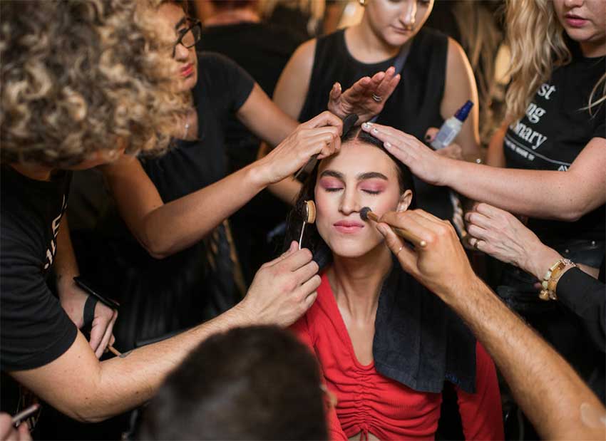 Career Opportunities at Aveda Institute Maryland woman having her make up applied by many different Aveda Estheticians and Cosmetologists